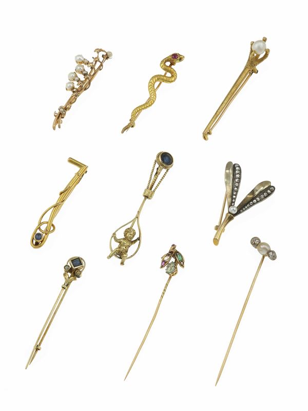 Two pins and seven brooch with different subjects