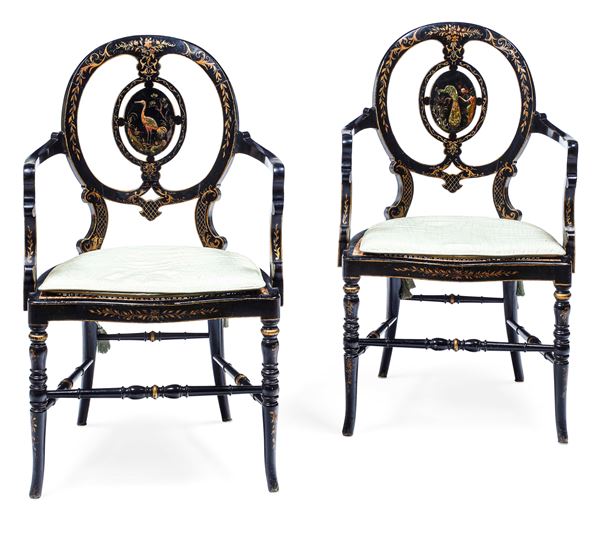 Coppia di sedie con braccioli in legno ebanizzato. XIX secolo