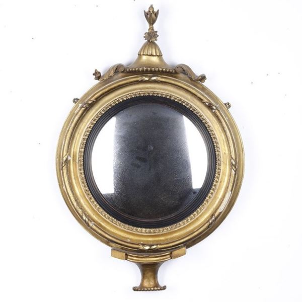 Specchiera circolare in legno intagliato, dorato ed ebanizzato. XIX secolo