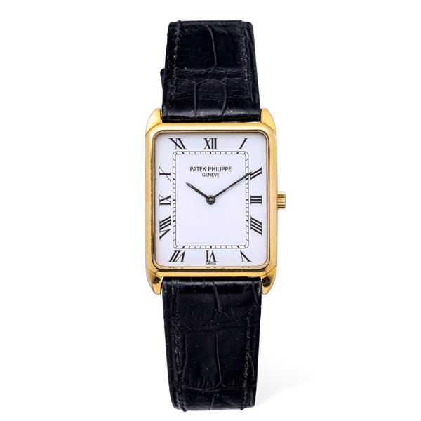 Patek Philippe - Refined rectangular gondolo in 18k yellow gold, white dial with Roman numerals and Chemin de Fer minuteria, manual winding with box and warranty
