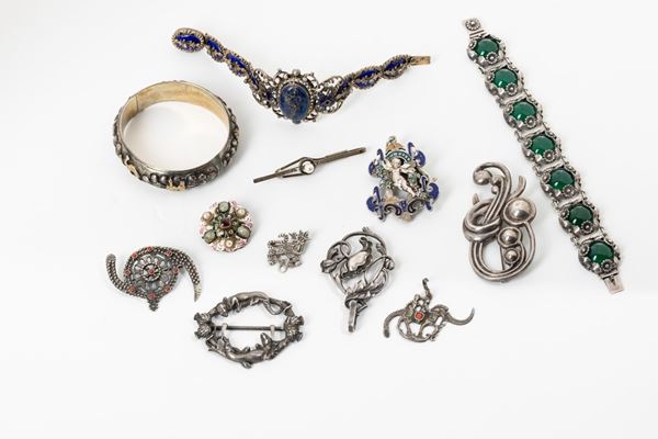 Twelve silver and silver-plated pieces, with enamels and semiprecious stones