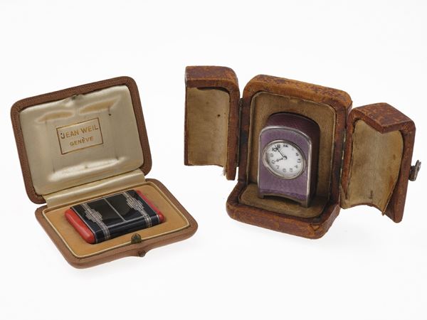 Two enamel travel watch. Numbered 5929 and 825925. Fitted case