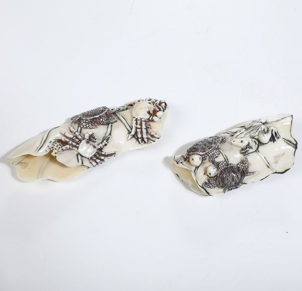 Coppia di okimono in avorio marino a decoro con tartarughe e granchi, Giappone, periodo Meji (1868-1912)