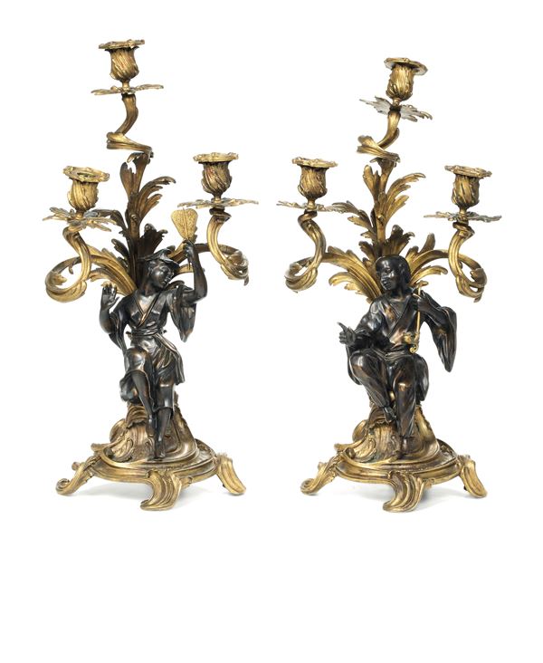 Coppia di candelabri a tre fiamme in bronzo dorato e patinato. Francia XIX secolo