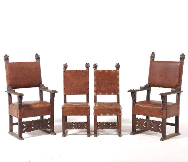 Due poltrone e due sedie in legno intagliato. Italia XVII secolo