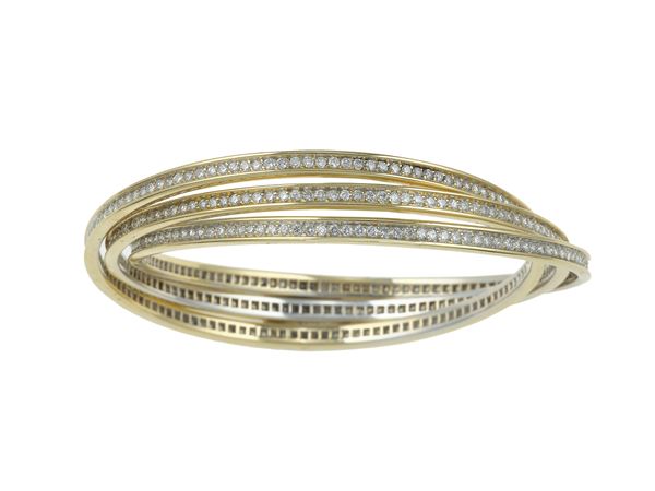 "Trinity" gold and diamond bangle. Signed and numbered Cartier n. 278895