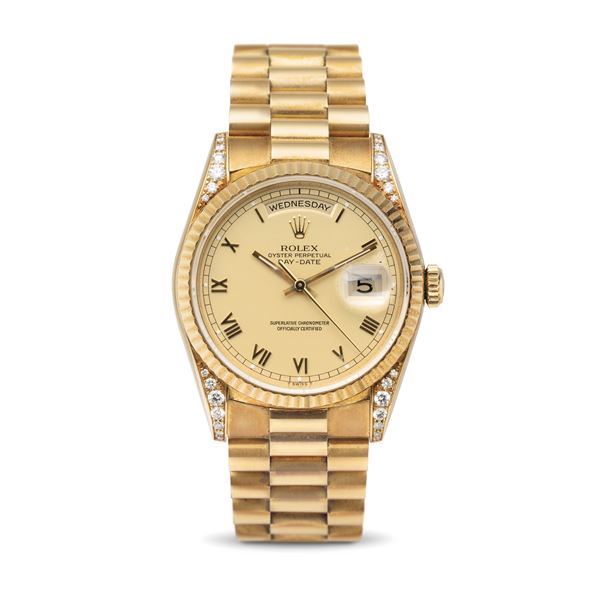 Rolex - Rare and precious Daydate ref 18338 in 18k yellow gold set with diamonds on the lugs, matt champagne dial with applied Roman numerals, complete with original warranty