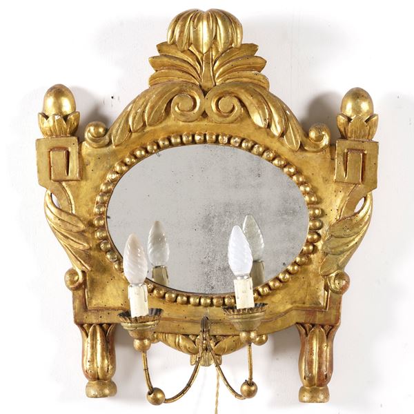 Specchiera a due luci in legno intagliato e dorato. XVIII-XIX secolo