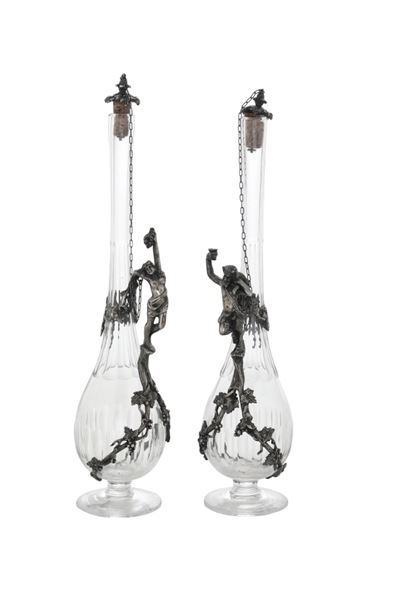 Bottiglie in cristallo, con manici a figure maschili in metallo, XX secolo