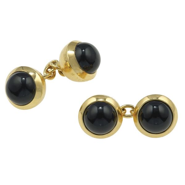 Pair of gold and onyx cufflinks. Signed and numebered Cartier B3992