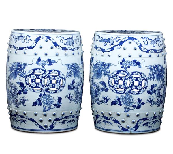 Pair of blue and white porcelain stools with floral motifs and dragons, openwork and relief decoration, China, 20th century