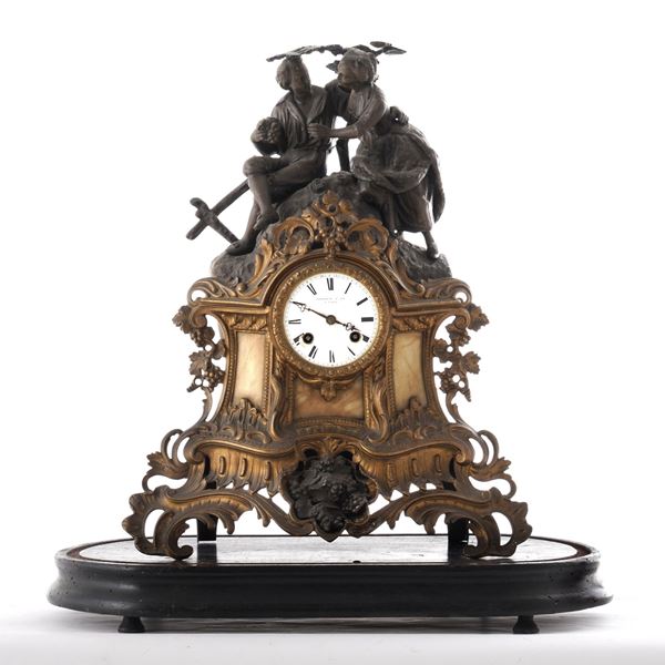 Pendola da tavolo in metallo dorato e brunito. XX secolo