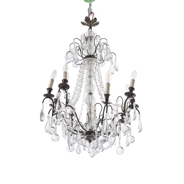 Lampadario con fusto vetro e nove bracci in metallo. XX secolo