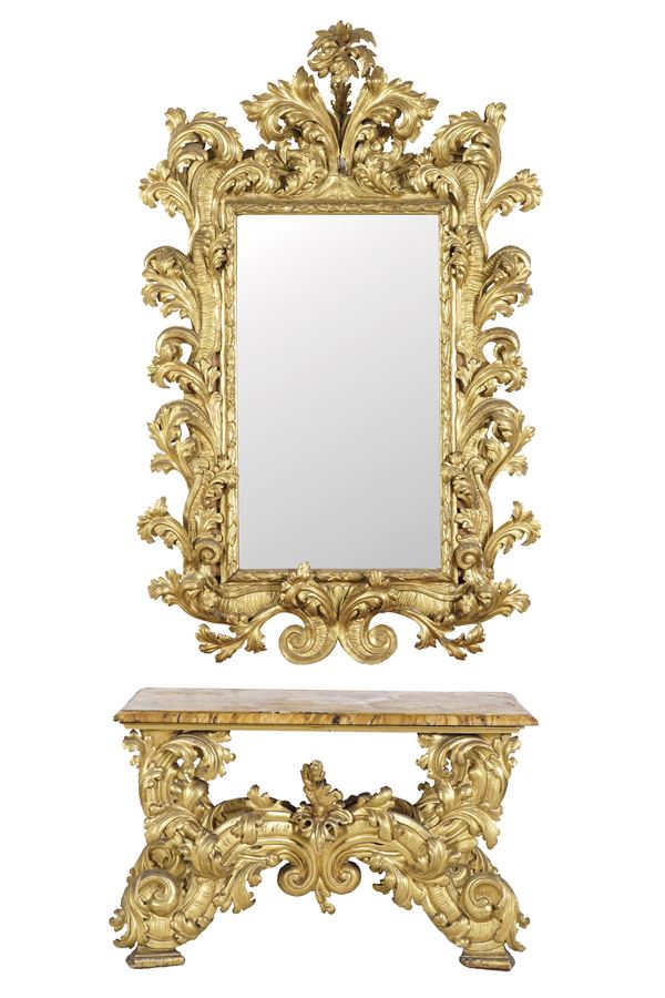 Imponente consolle con specchiera di gusto barocco in legno scolpito e dorato. XIX secolo