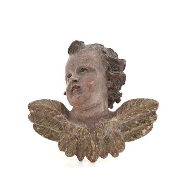 Testa di cherubino in legno scolpito e dipinto. XVIII secolo