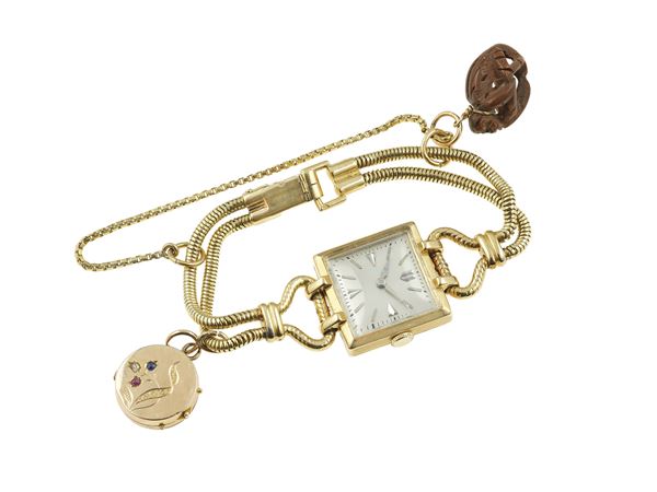 Gold lady's wristwatch with charms. The movement has not been tested for the accuracy of time and may need a service