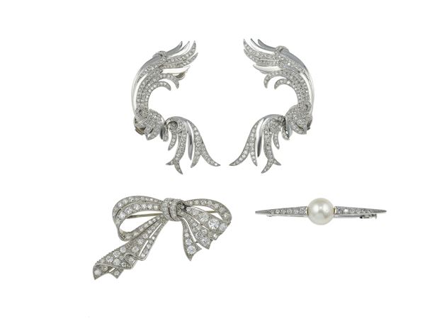 Two platinum and diamond brooches and a pair of diamond, platinum and gold earrings