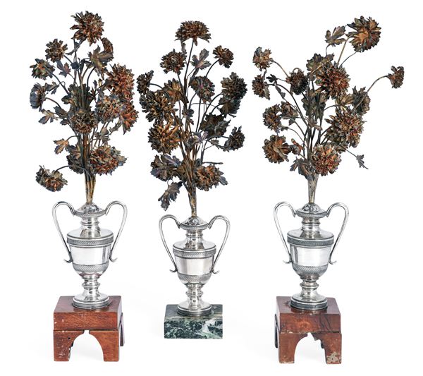 Gruppo di tre portapalme in argento modellati come vasi biansati e tralcio fiorito. Napoli XIX secolo