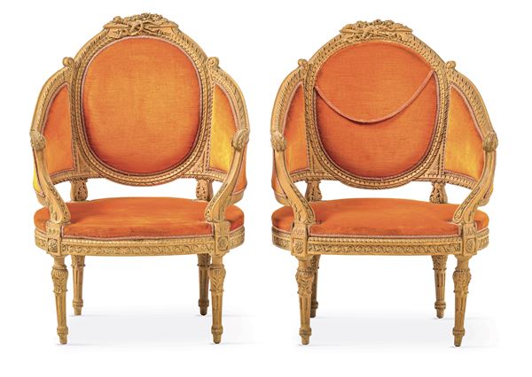 Coppia di poltrone a pozzetto in legno intagliato. XX secolo