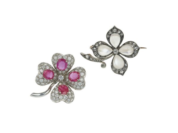 Two dimond, ruby, clair del lune, gold and silver brooches. (Shamrock brooch inventory number 7586)