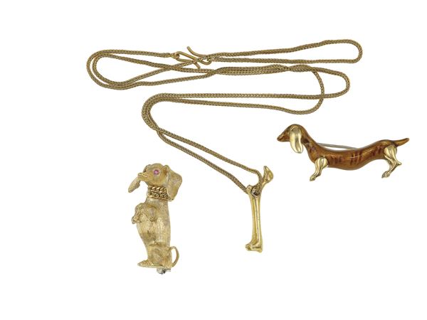 Two gold brooches and one gold pendent necklace