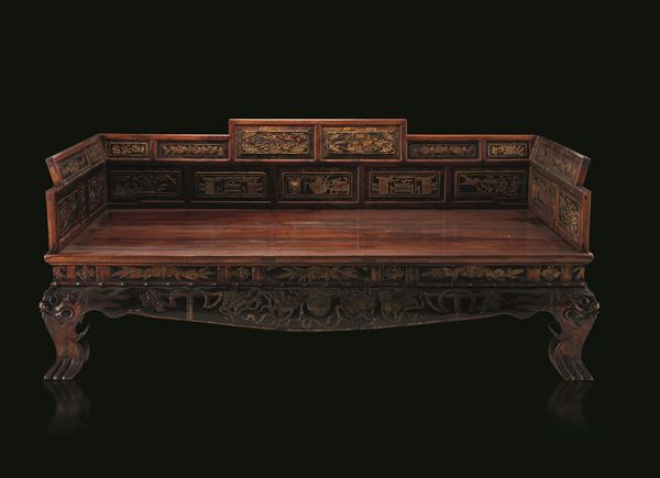 Camphor wood sofa/bed carved with gilding and inscriptions, panels depicting scenes of common life and nature scenes, dragon-shaped legs, China, Qing Dynasty, 19th century