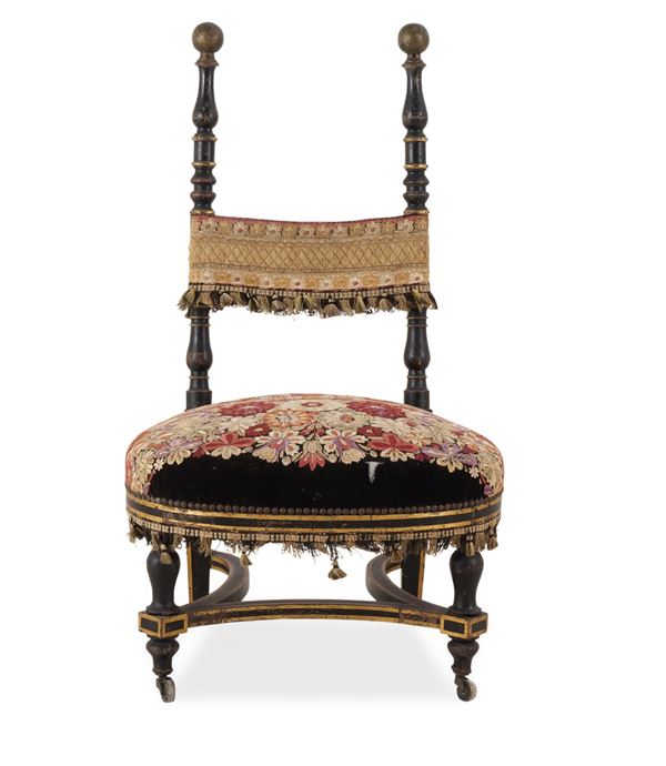 Sedia da balia in legno intagliato, dipinto e dorato. XIX secolo