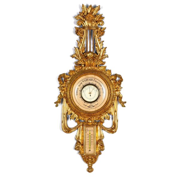 Barometro-termometro entro cornice in legno intagliato e dorato. XIX secolo