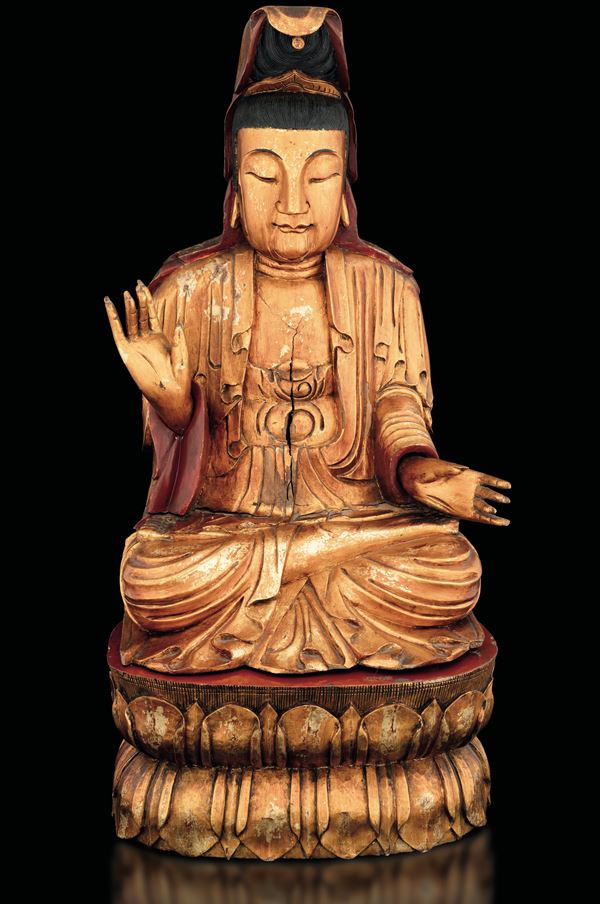 Wooden Guanyin figure on double lot flower with traces of polychrome and gilding, China, 19th century