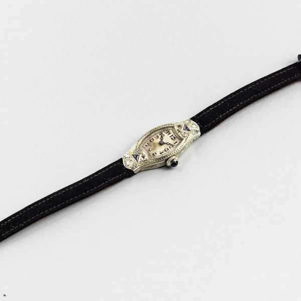 Orologio da sera in oro bianco 18k, brillanti e pietre colorate, quadrante argentè con lancette Breguet,  [..]
