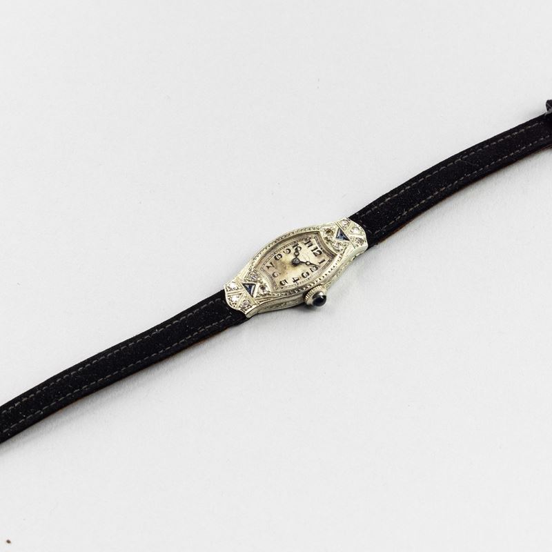 Universal Gen&amp;#232;ve : Orologio da sera in oro bianco 18k, brillanti e pietre colorate, quadrante argentè con lancette Breguet, carica manuale, 23,5x14 mm  - Asta Orologi da Polso - Cambi Casa d'Aste