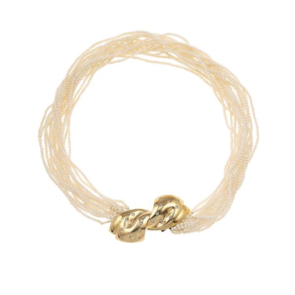 Multi-strand necklave with small pearls, gold clasp with small diamonds. The clasp can be trasformed into a brooch