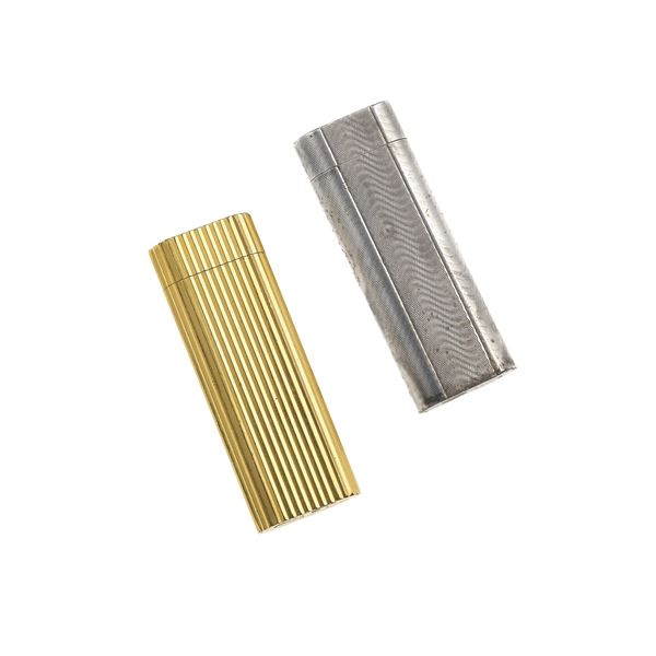 One gold plated lighter and onle silver plated lighter. Signed Cartier Paris, numbered D50626 and 32725