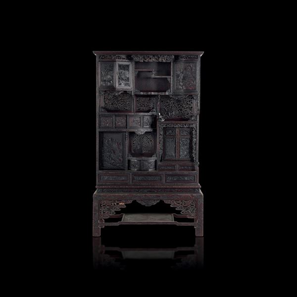 Richly carved wooden cabinet by Homu depicting a landscape scene with floral motifs, China, Qing Dynasty, 19th century