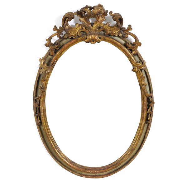 Cornice ovale in legno intagliato, laccato e dorato. XVIII-XIX secolo