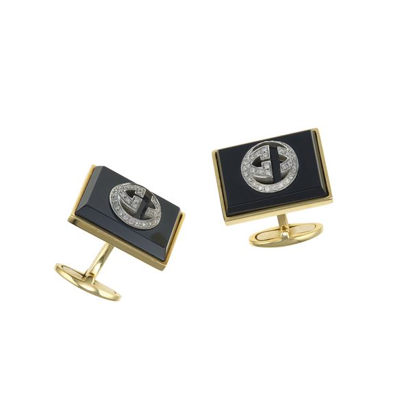 Pair of onyx, diamond and gold cufflinks. Engraved Gucci. Fitted case