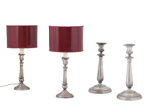 Quattro candelieri in metallo argentato. XX secolo