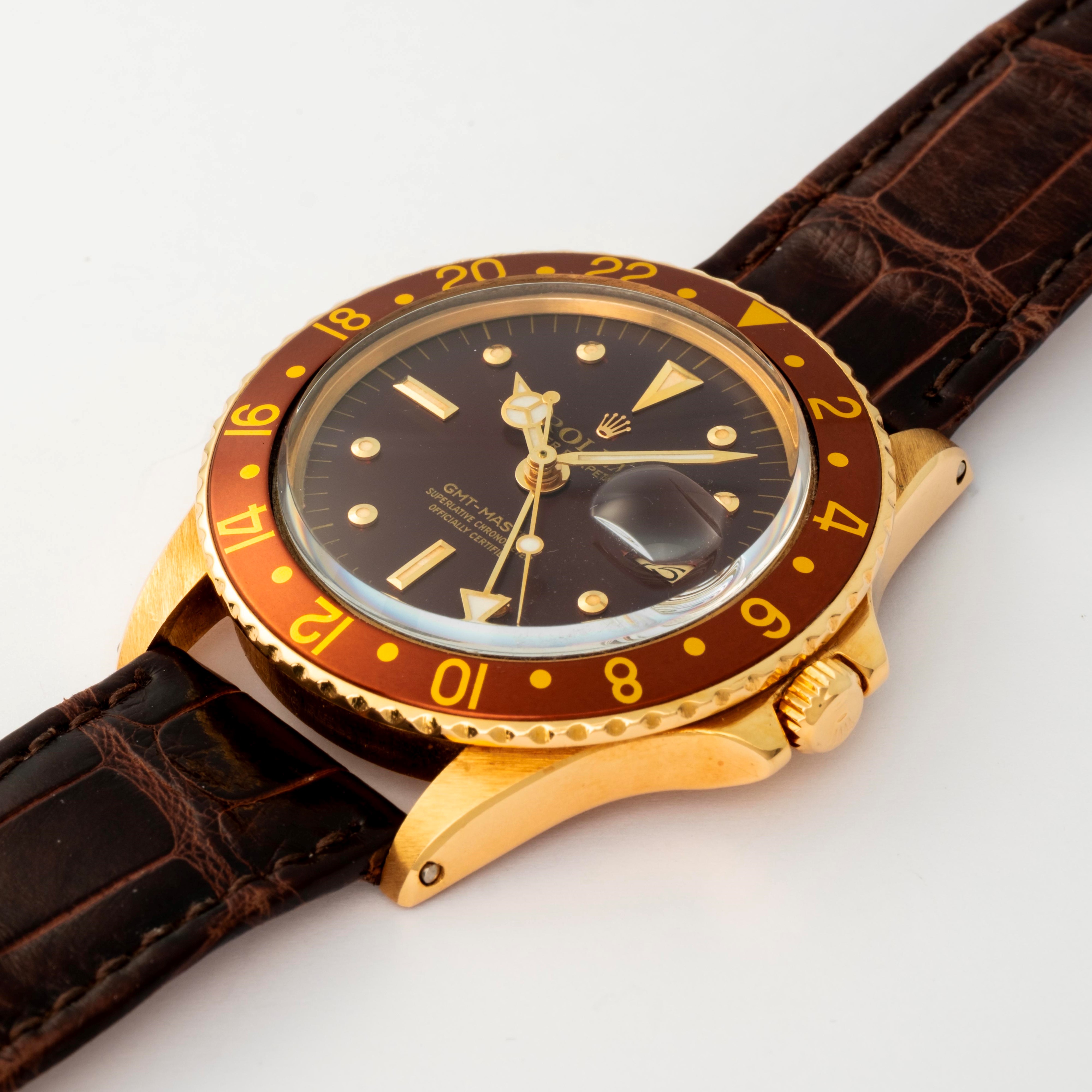 Rolex - GMT Master ref. 1675 in oro giallo 18k, quadrante marrone soleil 'Nipple', circa 1977