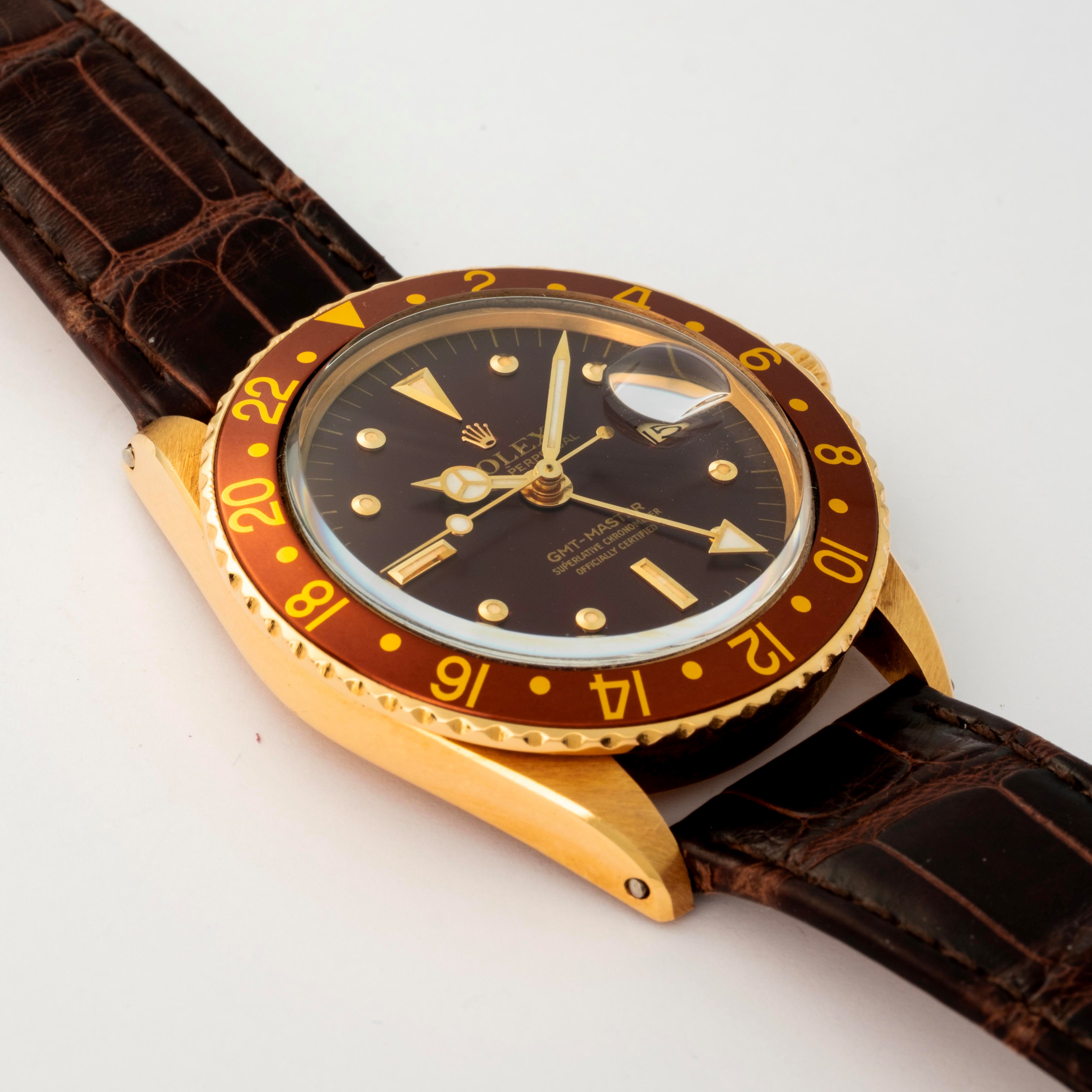 Rolex - GMT Master ref. 1675 in oro giallo 18k, quadrante marrone soleil 'Nipple', circa 1977