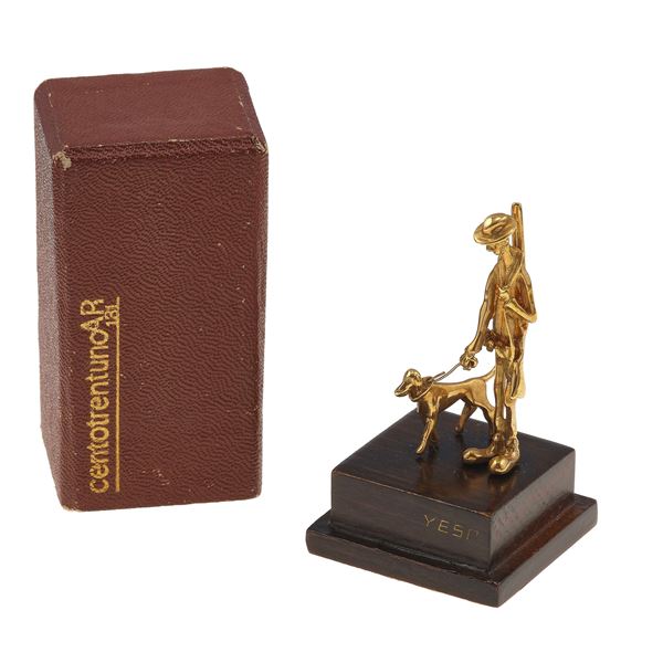 Small gold "hunter with dog" figurine on wood base