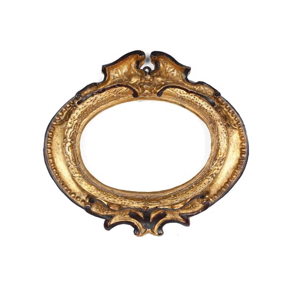 Cornice in legno intagliato, dorato con profili ebanizzati. Italia centrale XVII-XVIII secolo