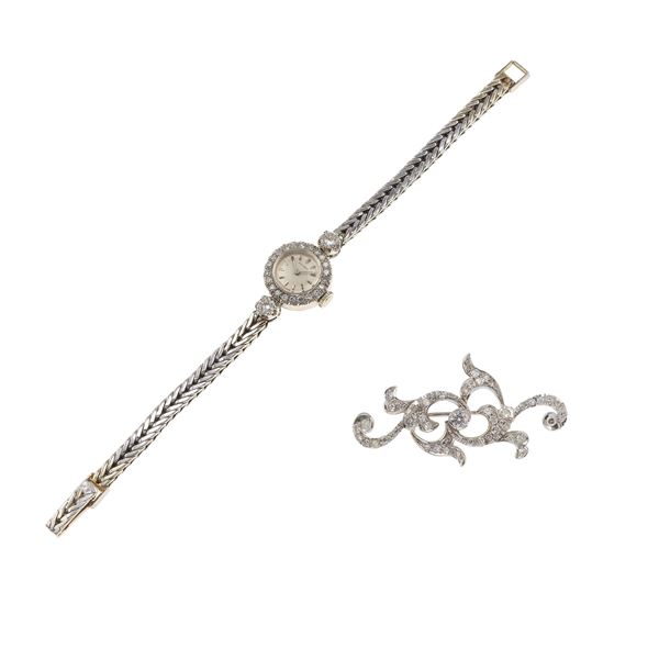 Diamond and gold lady’s wristwatch and brooch. The watch’s movement have not been tested for the accuracy of time and may need a service