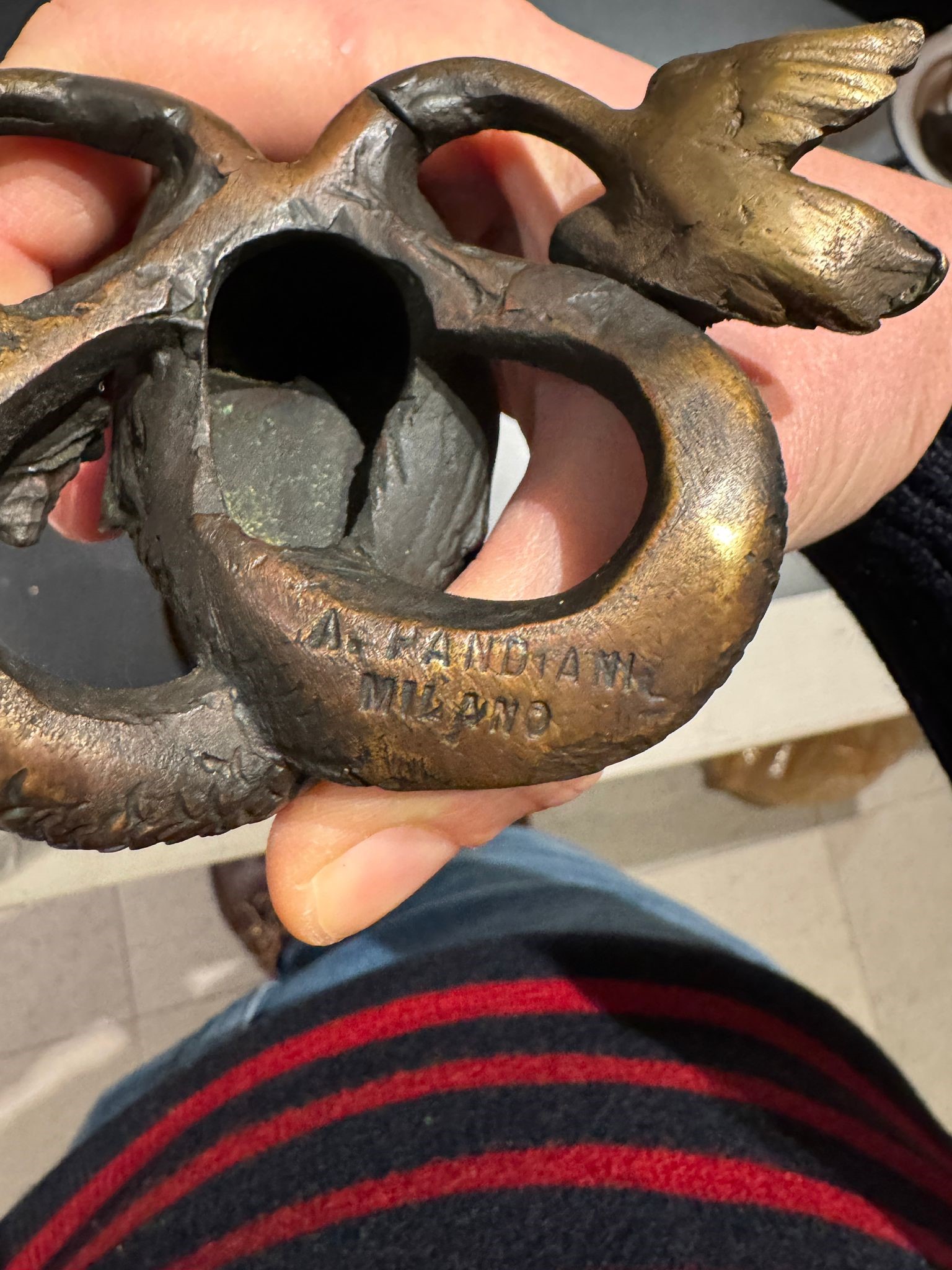 A. Pandiani Milano, Coppia di candelieri a foggia di tritoni, bronzo fuso e patinato