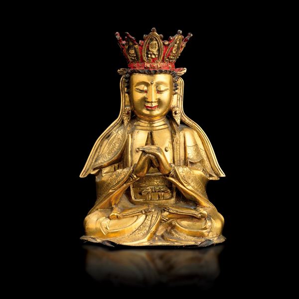 Gilded bronze figure of a crowned Buddha with traces of red monochrome, floral decorations, China, Ming Dynasty (1368-1644)