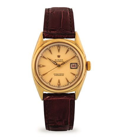 Oyster Perpetual Ovettone ref 6075 in oro giallo 10k, quadrante champagne con datario Roulette, c...