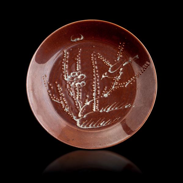 Brown-ground porcelain plate depicting a tree with relief decoration, China, Qing Dynasty, Kangxi period (1622-1722)