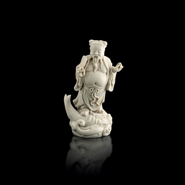 Figure of a sage and fish in Blanc de Chine Dehua porcelain, China, Qing Dynasty, 19th century
