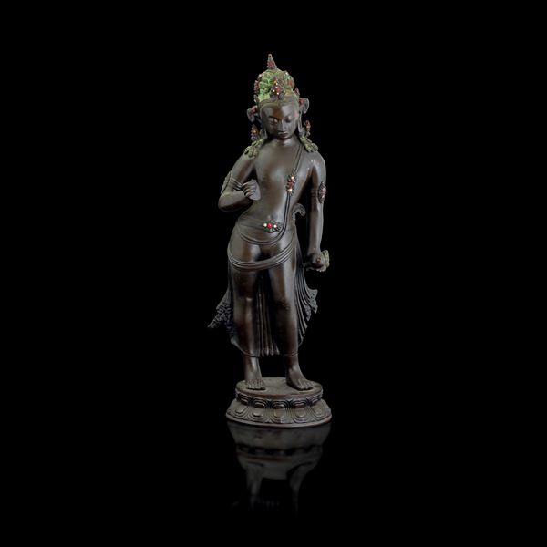 Bronze standing Buddha figure on double lotus flower with polychrome details, China, Qing Dynasty (1644-1912)