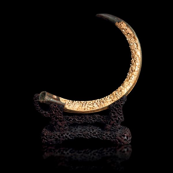 Extraordinary and monumental carved mammoth tusk depicting scenes of everyday life with inscriptions, China, 20th century