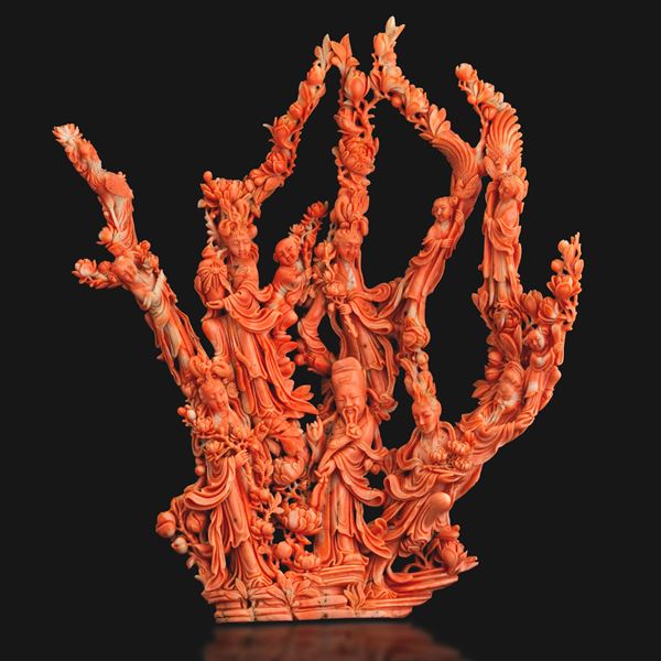 Large group carved in coral depicting a dignitary with maidens and children, with floral motifs in relief, China, Qing Dynasty, 19th century